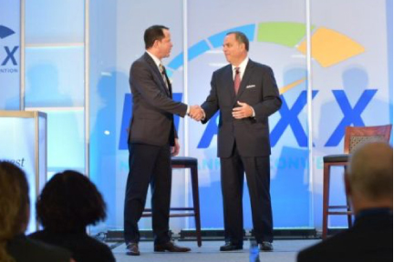 NWCUA President & CEO Troy Stang greets CUNA Mutual's Bob Trunzo on the MAXX stage.