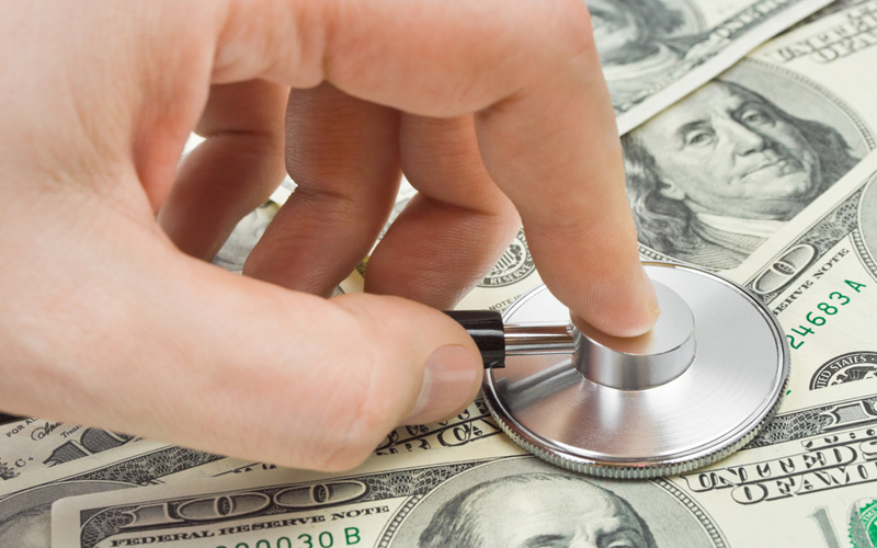 Picture of Hand with stethoscope and money