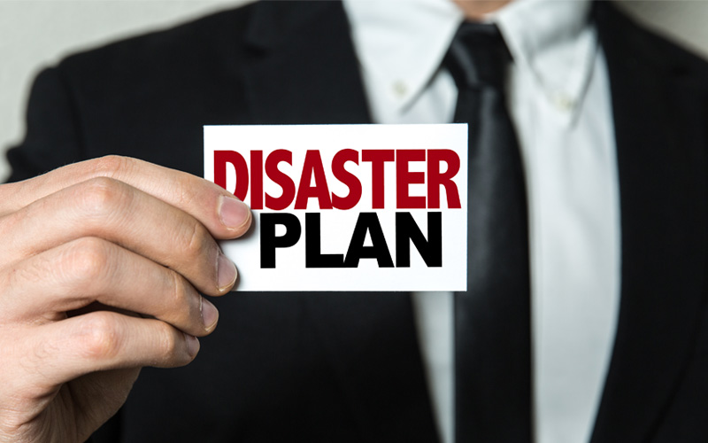 Picture of man holding disaster plan sign