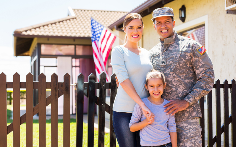 Picture of happy american soldier reunited with family outside their home