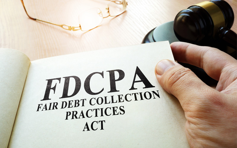 Photo of Fair Debt Collection Practices Act FDCPA on a table.