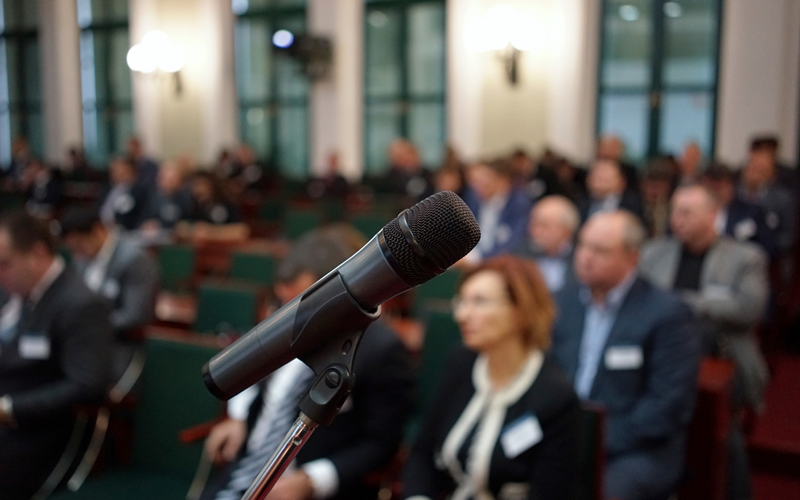Picture of Microphone in focus against blurred audience