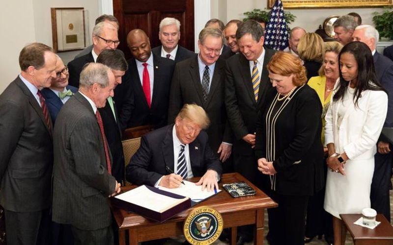 Picture of President Trump signing S2155